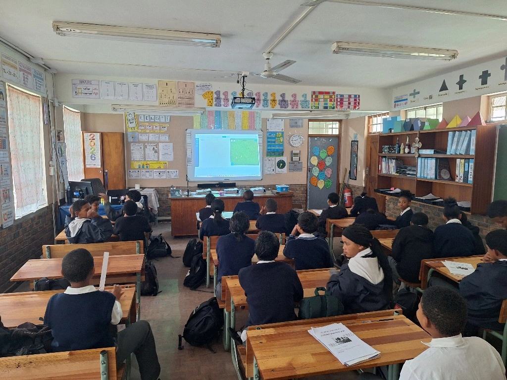 Students at a Thadus CodeLabs centre in Stellenbosch, South Africa, watching a lesson on the projector